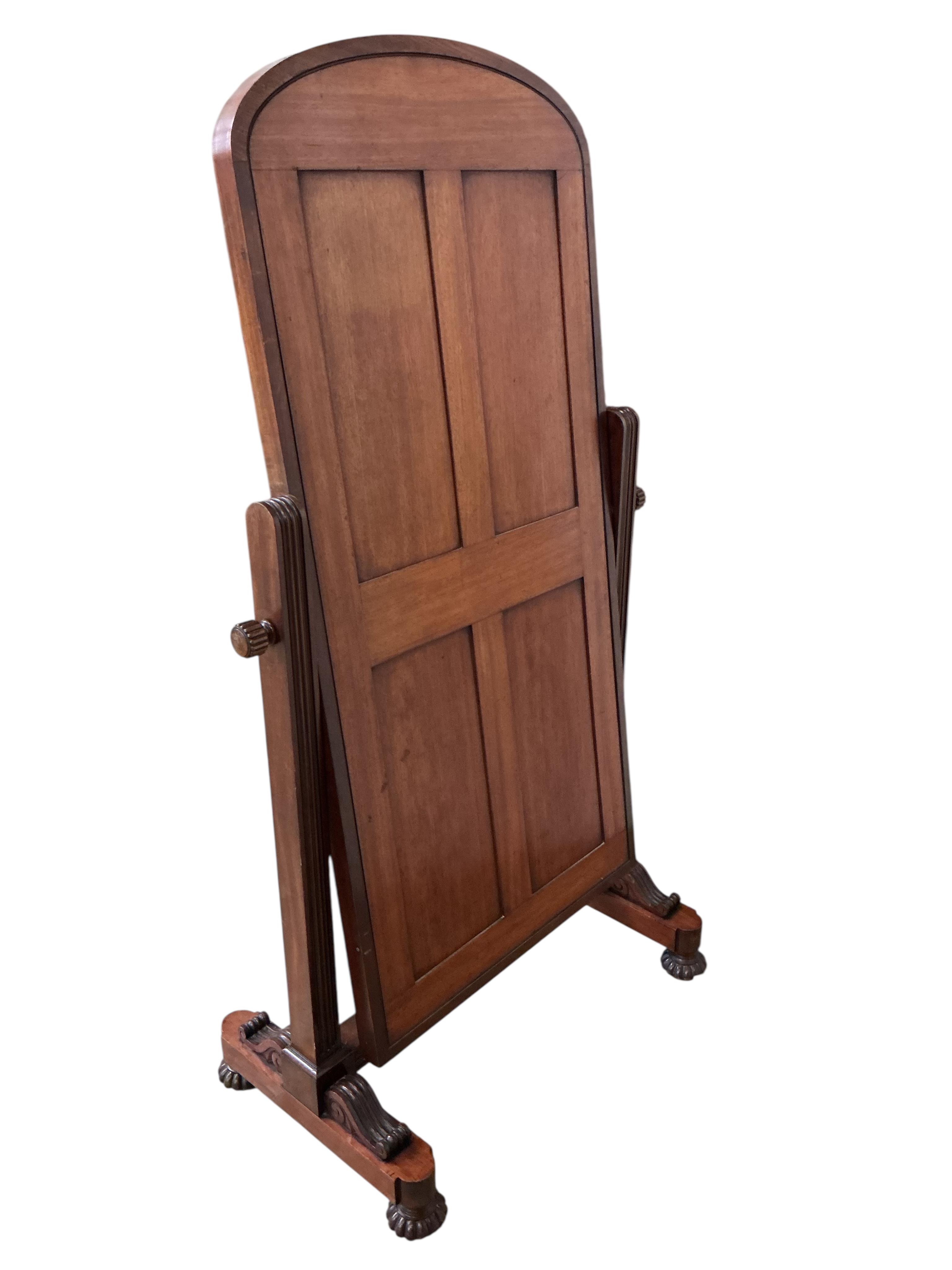 A Victorian mahogany cheval mirror, with arched plated and fluted bun feet, width 92cm, height 170cm